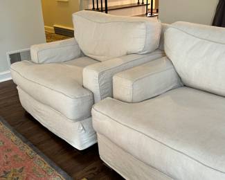 Pair of Quatrine Furniture Linen Arm Chairs. Very comfortable chairs in a nice neutral color. They match the sofa in lot 4 and are in very good condition with some light wear to the edges where there are loose threads which could be trimmed. 

The slip cover is removable/washable and replacements can be ordered from Quatrine

Each measures 41" x 43" x 32.5" 
