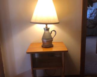 Beautiful pewter lamp on a finely crafted table