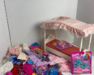 Barbie bed with clothes and hangers