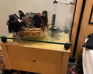 Another view of the nightstand, shown with women's scarves and lamp