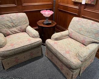A matched set of armchairs is shown with a round side table and french blown glass with silver base