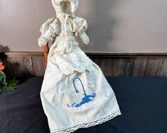 Vintage cloth doll with needlepoint on dress 21"L, minimal wear and marks, with rush seat wooden chair