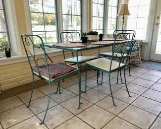 Glass topped wrought iron table and 4 chairs