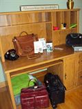 Computer desk and lots of leather totes & carry-ons