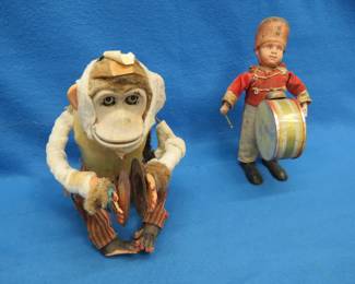Lot 379. Vintage Musical Jolly Chimp and Celluloid Windup Solider