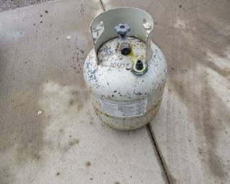 Lot 440. Full 20lb propane tank with an old style valve