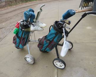 Lot 427. His and Hers golf club sets with pull carts
