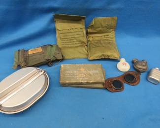 Lot 85. Military collectibles including a pneumatic life preserver, mess kit, oilers, and more