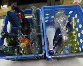 Lot 271. Two blue milk crates with colored bottles