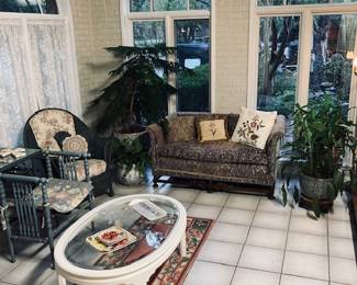 Beautiful Sun Room with Furniture, Plants and Rug.