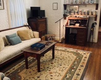 Den full of Vintage Furniture. Sofa, Roll Top Desk, Table and Collectable Beer Steins.