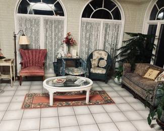 Beautiful Sun Room with Furniture, Plants and Rug.