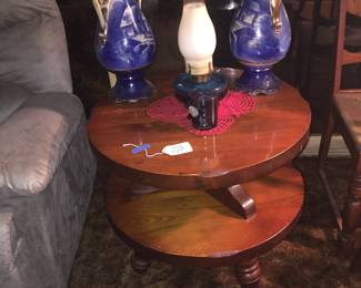 A pair of large blue vases team well with a blue hurricane lamp. The table holding them appears plenty sturdy with lots of life for a new chapter. 
