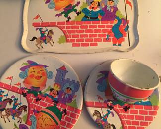 A partial set of tin toy dishes show Humpty Dumpty. The set is unmarked. 