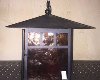 A metal and glass lantern with a Stickley-inspired design.  