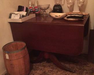 A Duncan Phyfe-style table has two leaves and table pads. Here, it holds a few kitchen goodies and stands near a nail keg in great condition. Imagine that little barrel with a rustic Christmas tree. 