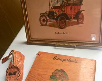 Set a touring or traveling theme with a framed print and souvenir coin purse and wood album. 