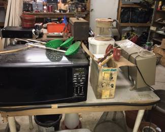 A microwave, ice fishing gear and a battery charger. 