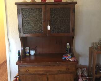 An unusual hutch offers display space on top and between cabinet doors. This piece could work in a variety of ways in different rooms. 