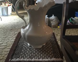 A small table holds a pitcher that’s seen its share of glue yet still could hold holiday greens in style. 