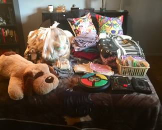 A full-size bed has a headboard with ample room for books and more. Here, it does double duty holding a mix of blankets, throws and plush toys. 