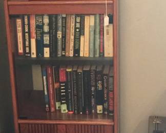 This cabinet is great at corralling books and could also hold decorative items. The case on the right, which looks like it could well serve a spy, offers safe space to stow cassette tapes n