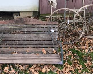 Warmer, care-free days spring to mind with this porch swing and old implement wheels. 