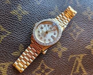 Woman's Gold and Diamond Rolex  - Louis Vuitton Jewelry Bag. 