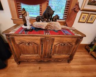 Rustic Southwestern Cabinet. Southwestern Rug. Bronze Bear Sculpture. Asian Sculpture. On the far right...Southwestern Sculpture 'The Gatherer' by Sally Kimp. On far left a very unique Sculpture 'Waiting' by James Roybal. 