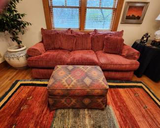 Thomasville Rust/Red Sofa. Southwestern Patterned Ottoman. Carpet. Large Plant Urn. Faux Plant. Handwoven Carpet. 