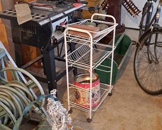 Hose on Wheel; planter; Metal Shelf; Craftsman Work Table; Bicycle; and assorted other tools.