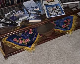 Assortment of WWII Military Books; Ephemera / Paper Goods, dating back to the 1940s; Pair of Silk Sweetheart Pillowcases; and wood coffee table.