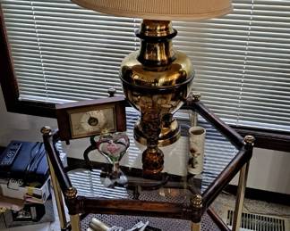 Hexagon Glass/Brass & Wood End Table - Has a Cane Bottom Shelf; Brass Lamp; Art Lamp; and assorted decor.