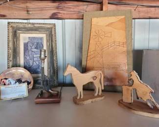 #10024 • Lot Of (2) Wooden Horse Statues, Porcelain Collector Plate, (2) Framed Art, Gun Lamp
