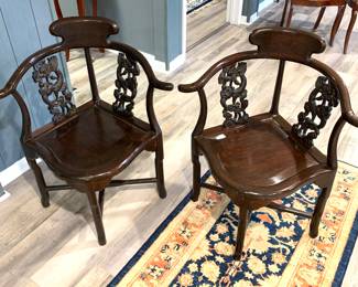 Pair of hand carved oriental corner chairs