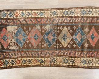 403	Caucasian Style Runner Rug	"Caucasian style runner rug. Repeating diamond forms and animal motifs against polychromatic field. Heavy fading, wear, losses and tattering throughout rug and fringe. Heavy warping throughout. 

2' 7"" x 7' 4 1/8"". 7 lbs."

