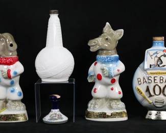 81	Lot of Vintage Liquor Decanters	Lot of 5 vintage whiskey and rum bottles. Pair of Jim Beam Beam's Trophy donkey and elephant clown porcelain bottles, Beam professional baseball's 100th anniversary porcelain bottle, 1939 World's Fair milk glass bottle, Pusser's Rum British navy porcelain bottle. Donkey 12 1/4"H. Losses to paper labels on all; donkey and elephant both missing corks, paper label taped onto ear of donkey, adhesive residue and paint loss to both; World's Fair rusting to cap, British Navy cork broken.
