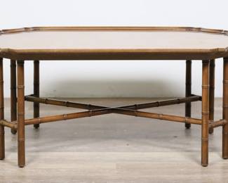 217	Kittinger Hollywood Regency Style Cocktail Table	"Mid Century Modern Hollywood Regency style cocktail table by Kittinger. Buffalo, NY,  20th century. Walnut veneer, bamboo form legs and stretcher. Kittinger metal tag, sticker label with pattern and serial numbers, and brand mark on underside of table top. Scratches, marks, scuffs and wear throughout wood of top. Nicks and chips to edges of top on molding. Scuffs, wear, and water damage to wood on legs. 

42"" W x 29 7/8"" D x 18 1/4"" H. 27 lbs. 

27 lbs."
