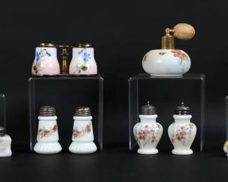 26	Lot of Wave Crest & Opaque Glass	12 pieces Wavecrest and other opaque glass. Hair receiver, C.F. Monroe Wave Crest banner mark; perfume atomizer, Wave Crest mark; 4 pairs of salt & peppers, all unsigned; double "binocular" toothpick / match holder, unsigned; paperweight, unsigned. Paperweight, 2 3/4"H. Tarnishing to tops of salt and peppers, some losses to patina on rim of "binoculars".
