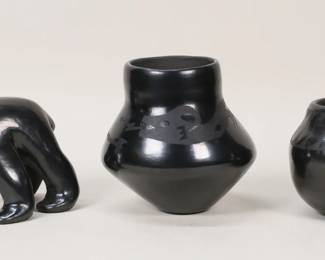 189	3 Pieces Yellowbird San Ildefonso Pottery	Yellowbird (Jose Victor Aguilar) (San Ildefonso Pueblo, 1945-). 3 pieces San Ildefonso blackware pottery. Bear, 3 1/2"H; two vases, taller 4 5/8"H. All signed on the underside Yellowbird San Ildefonso Pueblo and dated 87. Minor scratches to both vases.
