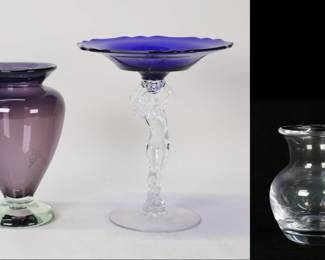 131	3 Pieces Art Glass Cambridge, Simon Pearce, Hahn	3 pieces art glass. Michael Hahn amethyst to clear vase, signed and dated '95 on the underside, 7"H; Simon Pearce vase with original box, 4 1/8"H; Cambridge figural compote, nude supporting a cobalt dish, 7 7/8"H.
