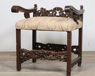 50	Carved Italian Baroque Style Low Back Chair	"Wooden carved Italian Baroque style low back chair. Heavily carved arms, splat, stretcher and legs, with later upholstery. Loss to wood on central carved crest on back splat. Chips and losses to wood on front left and back right feet. Split and crack to wood on underside of right arm. Arms are slightly loose. Split to wood on carved scroll on end of right arm. Wear and scratches throughout wood. Hole, pilling and wear to upholstery.

26 1/2"" W x 22"" D x 28 1/2"" H. 25 lbs."
