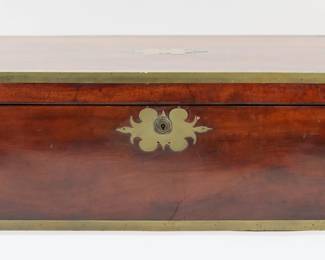 424	English Brass Inlaid Lap Desk	English lap desk, brass inlays, mounts and hardware. Lock marked J. Bramah. With side drawer. Closed 19 7/8"W x 11"D x 7 3/8"H, open 19 7/8"W x 22 1/4"D x 5 3/4"H. Scratches, chips and minor losses to wood on lid and throughout, scratches and losses to patina on brass, split to wood at center of front, chips to wood around escutcheon, chips to wood at top of secret drawer from locking mechanism, brass dented and separating at one corner, brass dented along back, brass dented on one side, interior desk detached on both sides, leather torn at seam and losses to leather throughout, hardware missing from interior of lid, crack to wood at one end of desk, chips to wood at corners of interior desk, lock untested (no key).
