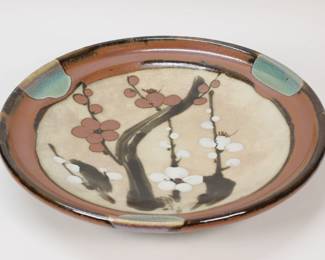 320	Shoji Hamada Style Stoneware Charger	In the style of Shoji Hamada (Japan, 1894-1978). Japanese Mashiko style stoneware pottery charger, cherry blossom decoration. Unsigned. 15 1/2"-diameter.
