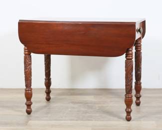 304	American Classical Drop Leaf Table	"American Classical drop leaf table in Pembroke form. 19th century. Mahogany, carved acanthus-form legs, and two drawers (one with brass knob pull.) Scratches, scuffs and wear  throughout wood of top and leaves. Nicks and scratches to wood on legs. Two back legs sit slightly askew. Chips to wood on one corner of top and leaf. 

21 5/8"" W x 36 5/8"" D x 28 1/2"" H. With leaves open: 39 1/2"" W x 36 5/8"" D x 28 1/2"" H.  47 lbs."
