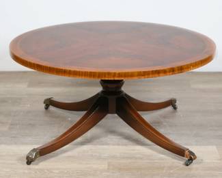 221	Regency Style Burlwood Coctail Table	"Regency style burlwood cocktail table. Burlwood and brass paw feet on casters. Scratches, scuffs, and wear throughout wood on top. Small chips to wood along edges of top. Nicks and chips tow wood on legs. One brass paw foot cap missing from one leg. One foot cap is loose. 

16 1/2"" H x 34 1/8"" diameter. 30 lbs."
