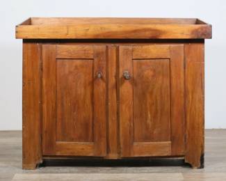 103	American Primitive Dry Sink	"American primitive rustic dry sink. 19th century. Maple, two doors, one fixed shelf. ""Dr. P.R. Koons"" painted onto back of cabinet. Marks, staining and wear throughout wood.  Door pulls are mismatched and are separated from doors. Cracking and losses to right front bottom corner of dry sink. Scratches to wood on right side. Chips to wood on left side near back left foot. Some separating to dovetailing at one corner of top.

42 7/8"" W x 18 3/8"" D x 33 1/4"" H. 75 lbs."
