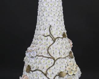 33	Meissen Style Schneeballen Lidded Vase	Meissen style porcelain "snowball" lidded vase / bottle. All over applied flowers and vines. 18 1/2"H. Chips to sections of raised flowers including large chip to pink flowers, leaves and vines chips throughout.
