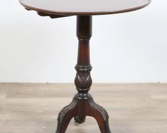 55	Chippendale Style Mahogany Tilt Top Table	"Chippendale style mahogany tilt top table. 19th century. Acanthus form center post with webbed claw-and-ball feet. Wear throughout mahogany. Small losses, nicks and scuffs to wood of legs and feet. Split and crack to wood on one end of table top. Chips to wood along molding of table top. 

Tilted: 42 7/8"" H. As table: 30"" H x 26 3/8"" diameter. 12 lbs."
