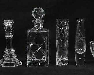137	6 Piece Crystal Lot Steuben, Tiffany, Orrefors	6 piece crystal lot, all signed. Steuben control bubble vase, 8 1/8"H; pair of Tiffany & Co. candlesticks, each 8"H; Tiffany & Co. vase, 8"H; Orrefors bowl, 4"H x 6 1/4"-diameter; Rogaska decanter, 10 1/4"H. Orrefors bowl chips to rim and base.
